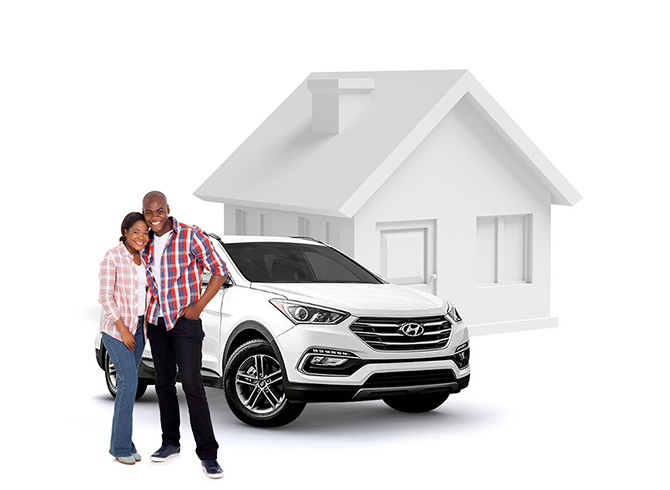 Happy couple standing with their new car outside their home.